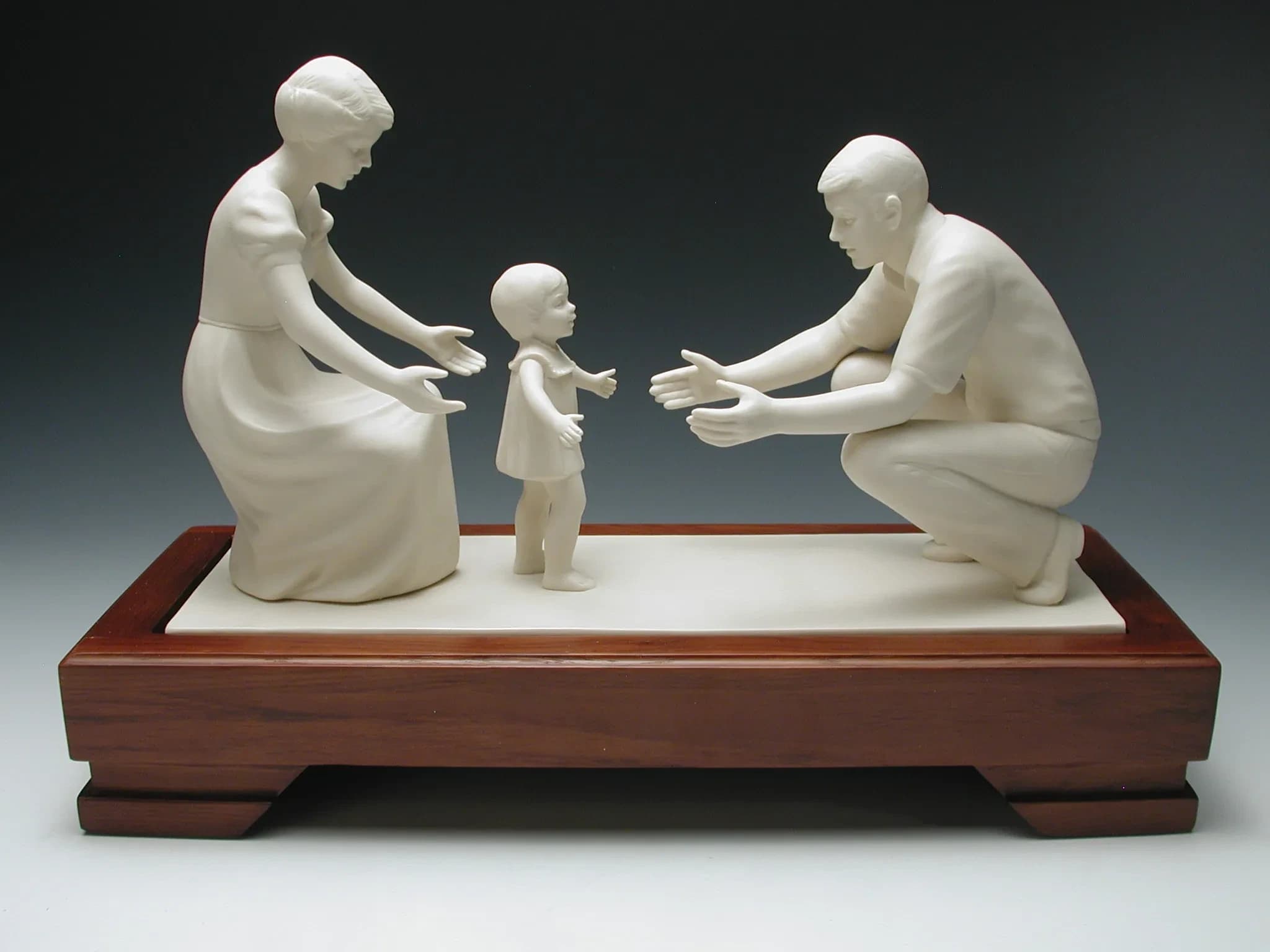 White porcelain figurine of a mother and father reaching out to a toddler taking her first steps between them, on a long timber base